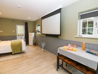 A bedroom with a bed and board games at Stone Lodge near Haltwhistle