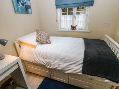 A bedroom with a bed and desk at Stone Lodge near Haltwhistle