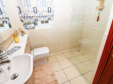 A bathroom with a sink, toilet, and shower at Stone Lodge near Haltwhistle