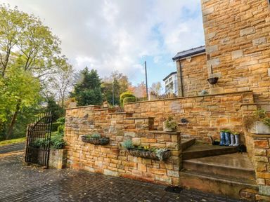 An outdoor entrance with steps and plants at Stone Lodge near Haltwhistle