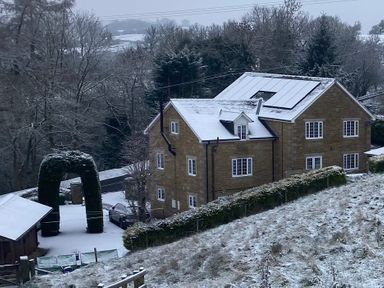 A house with trees and snow at Stone Lodge near Haltwhistle