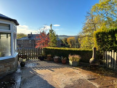 A garden with potted plants and a fence at Stone Lodge near Haltwhistle