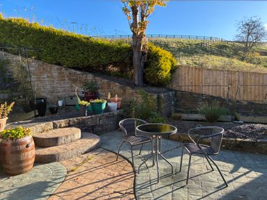 A garden with seating area and planters at Stone Lodge near Haltwhistle