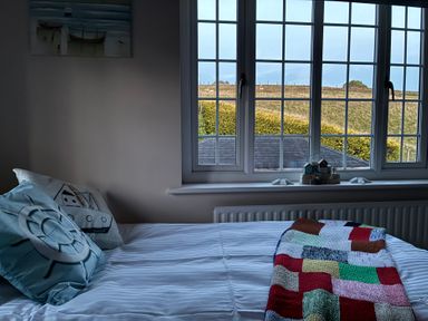 A bedroom with a bed and window view at Stone Lodge near Haltwhistle