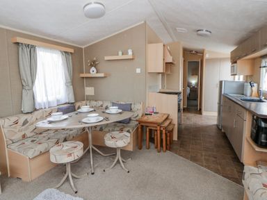 A dining room with a table and seating at Ger Y Mor in New Quay