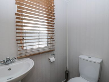 A bathroom with a toilet and sink at Ger Y Mor in New Quay