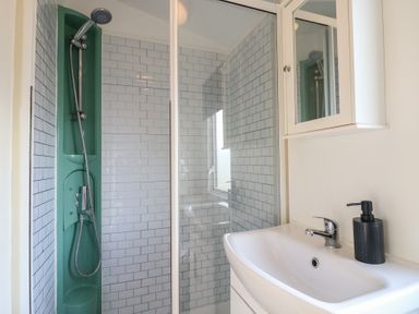 A bathroom with a shower and sink at 2 bed Caravan in Stowmarket