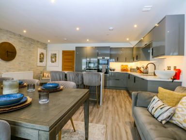 An open plan kitchen with dining area at 2 Glan Yr Aber Colwyn Bay