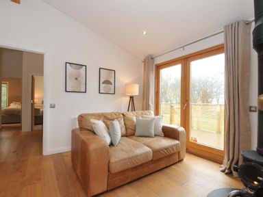 A living room with a sofa and lamp at 4 Southern Place in Dobwalls