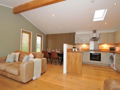 A living room with a sofa and dining area at 4 Southern Place in Dobwalls