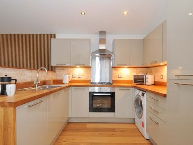 A kitchen with modern appliances and wooden countertop at 4 Southern Place in Dobwalls