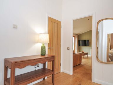 A hallway with a table and lamp at 4 Southern Place in Dobwalls