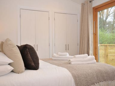 A bedroom with a bed and wardrobe at 4 Southern Place in Dobwalls