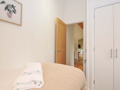 A bedroom with a bed and towels at 4 Southern Place in Dobwalls