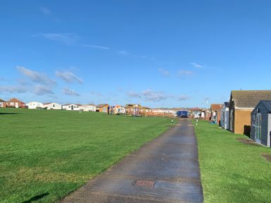 An outdoor area with a pathway and holiday cabins at Salt Air 130 @ Park Ave Holiday Village, Leysdown-On-Sea, Kent