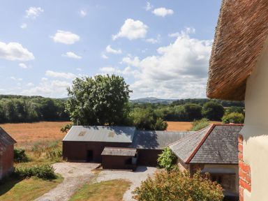A view of fields and outbuildings at The Cottage in Sampford Courtenay
