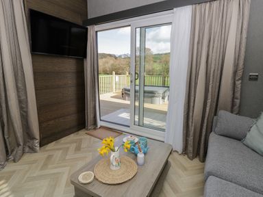 A living room with a sofa and table at Dawn's Rest in Nantmel near Rhayader