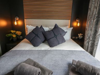 A bedroom with a bed and pillows at Dawn's Rest in Nantmel near Rhayader