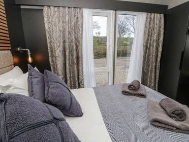A bedroom with bed and window at Dawn's Rest in Nantmel near Rhayader