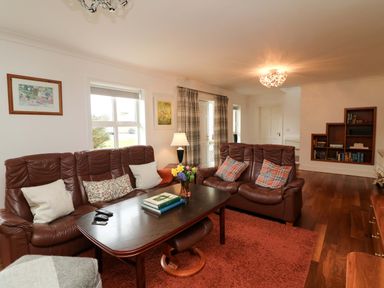 A living room with a sofa and coffee table at Sunnyside in River Chapel