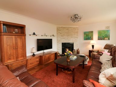 A living room with a television and sofa at Sunnyside in River Chapel