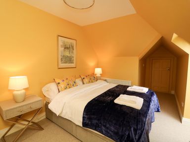 A bedroom with a bed and bedside table at Sunnyside in River Chapel