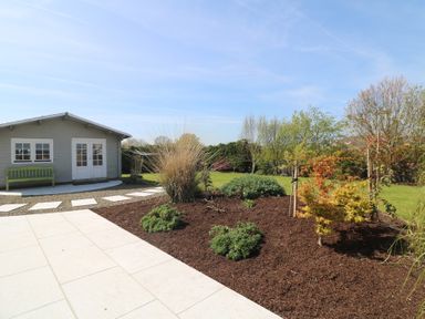 A garden with a shed and a bench at Sunnyside, River Chapel near Courtown, County Wexford