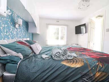 A bedroom with a bed and towels on it at Grosvenor 10 Llanarmon-Yn-Ial
