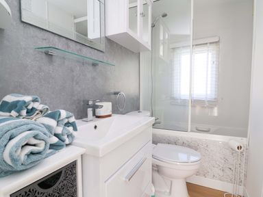A bathroom with a wash basin and shower at Grosvenor 10 in Llanarmon-Yn-Ial