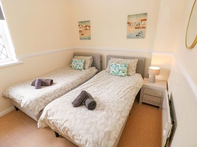 A bedroom with two single beds at The Wool Pack in Tenby