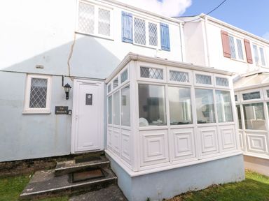 A conservatory with doors and windows at The Wool Pack in Tenby
