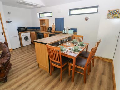 A kitchen with dining area and appliances at Brookview Kingfisher in Haverfordwest