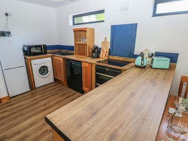 A kitchen with appliances and wooden countertops at Brookview Kingfisher Haverfordwest