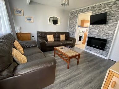 A living room with two couches and a coffee table at Chalet 57 in California, Norfolk