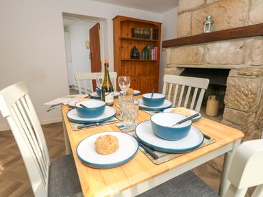 A dining room with a table set for a meal at NO 10 Fortuneswell