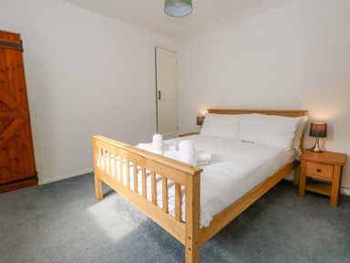 A bedroom with a bed and nightstand at NO 10 in Fortuneswell