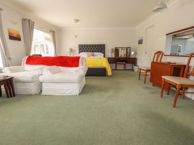 A bedroom with a bed and sofa at Tregoning annex in Lerryn near Lostwithiel