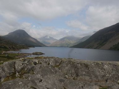 A view of mountains and lake with rocks in the foreground at Pandora Holmrook