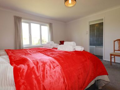 A bedroom with a bed and towels arranged on it at Tregoning in Lostwithiel