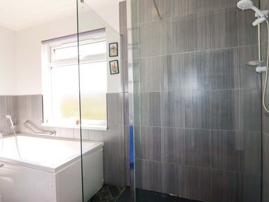 A bathroom featuring a bath tub and a shower at Tregoning in Lostwithiel