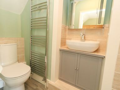 A bathroom with a toilet and sink at Rose Cottage in Osmington