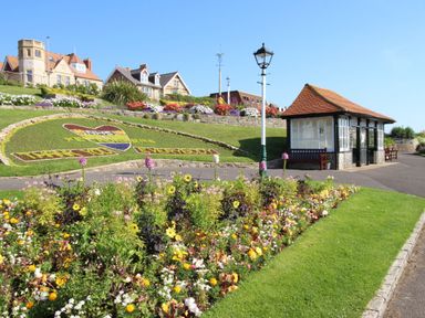 A flowerbed and a seating area at Rose Cottage in Osmington