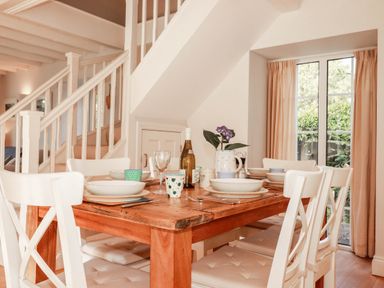 A dining room with a table and chairs at Bryher Cottage St Mawgan
