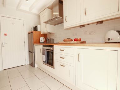 A kitchen with appliances and countertop at Bryher Cottage in St Mawgan