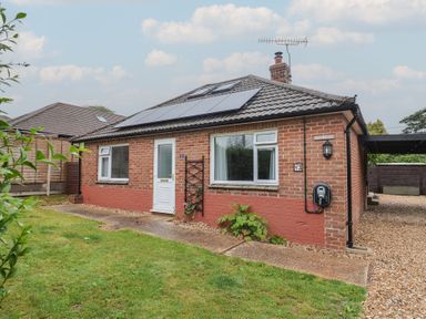 A front view of a bungalow with solar panels at 2 North Road, Maiden Newton, Dorset