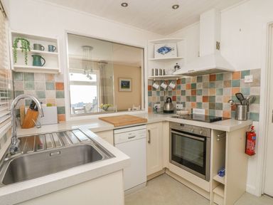 A kitchen with sink and appliances at Wootton Gray in Penzance