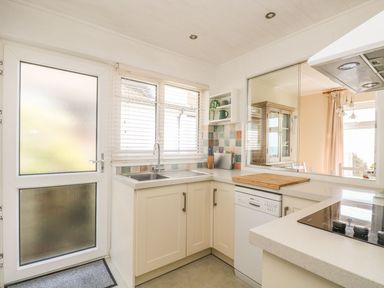 A kitchen with a sink and stove at Wootton Gray in Penzance