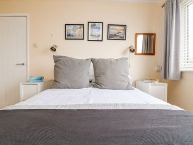 A bedroom with a bed and bedside tables at Wootton Gray in Penzance
