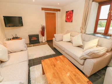 A living room with sofas and a coffee table at Maerdy Cwtch in Haverfordwest