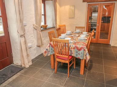 A dining room with a table set for meals at Maerdy Cwtch in Haverfordwest